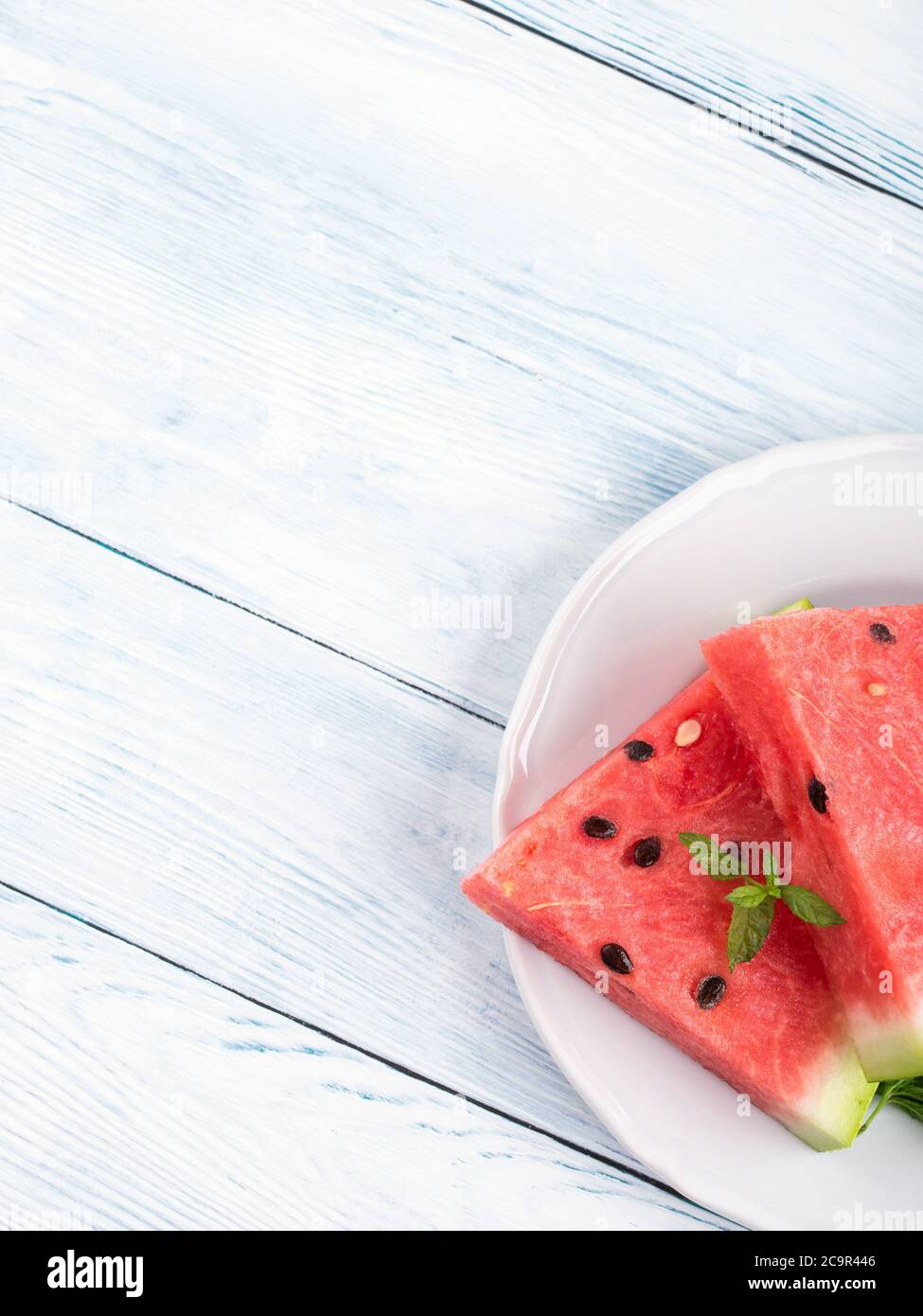 Watermelon slices on plate on white table Stock Photo