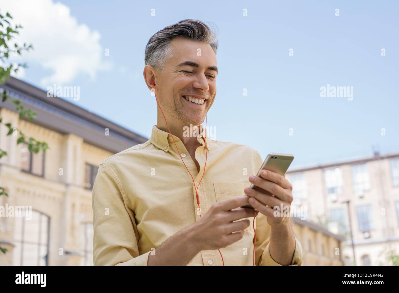 Old man walking phone hi-res stock photography and images - Alamy
