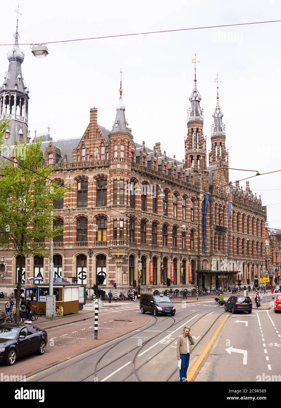 Magna Plaza or Maxima Plaza, Amsterdam, The Netherlands with many tourists, shoppers and busy traffic Stock Photo
