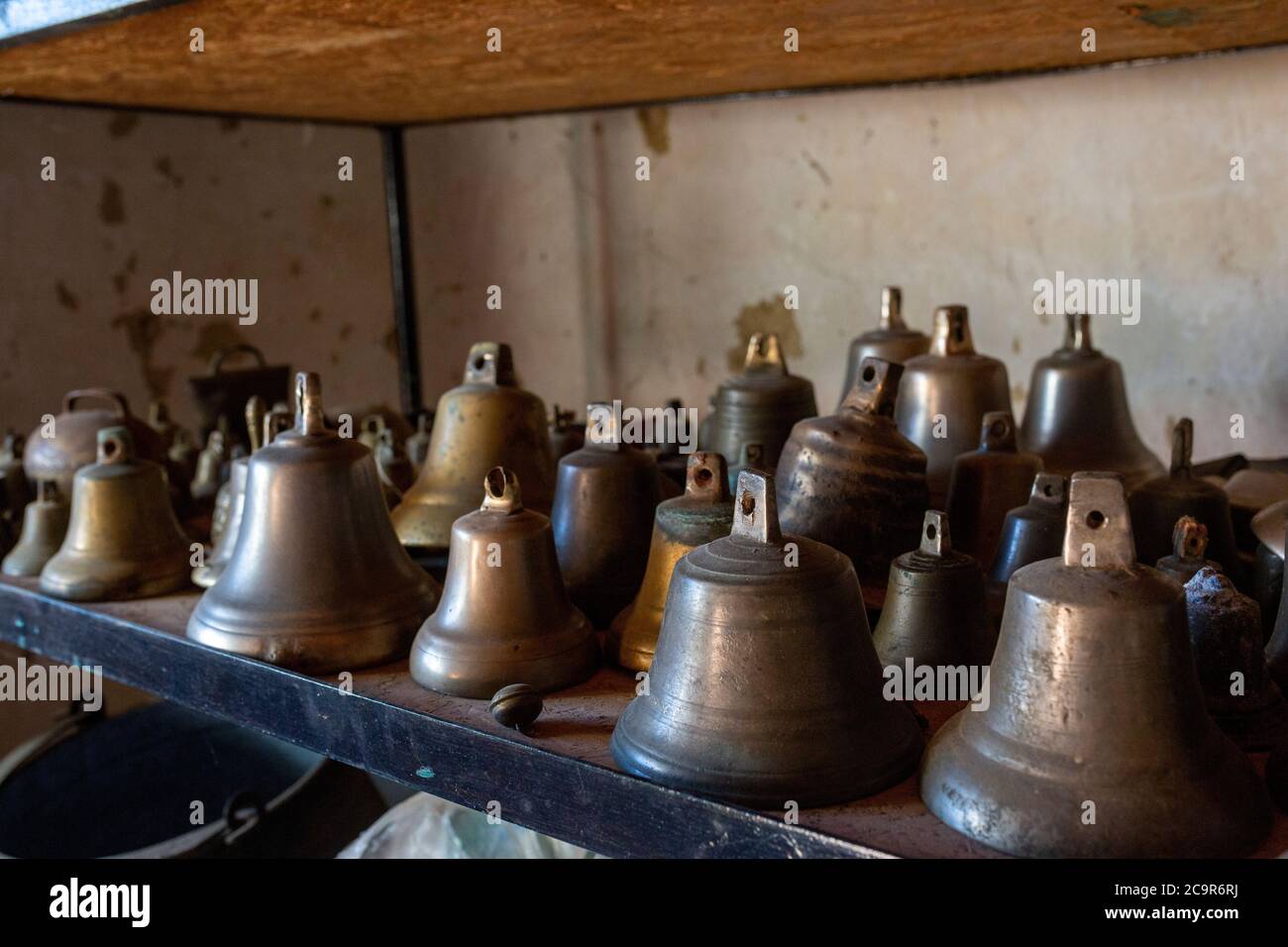 Collection of copper sheep bells in a shepherd home in rural Hungary Stock Photo