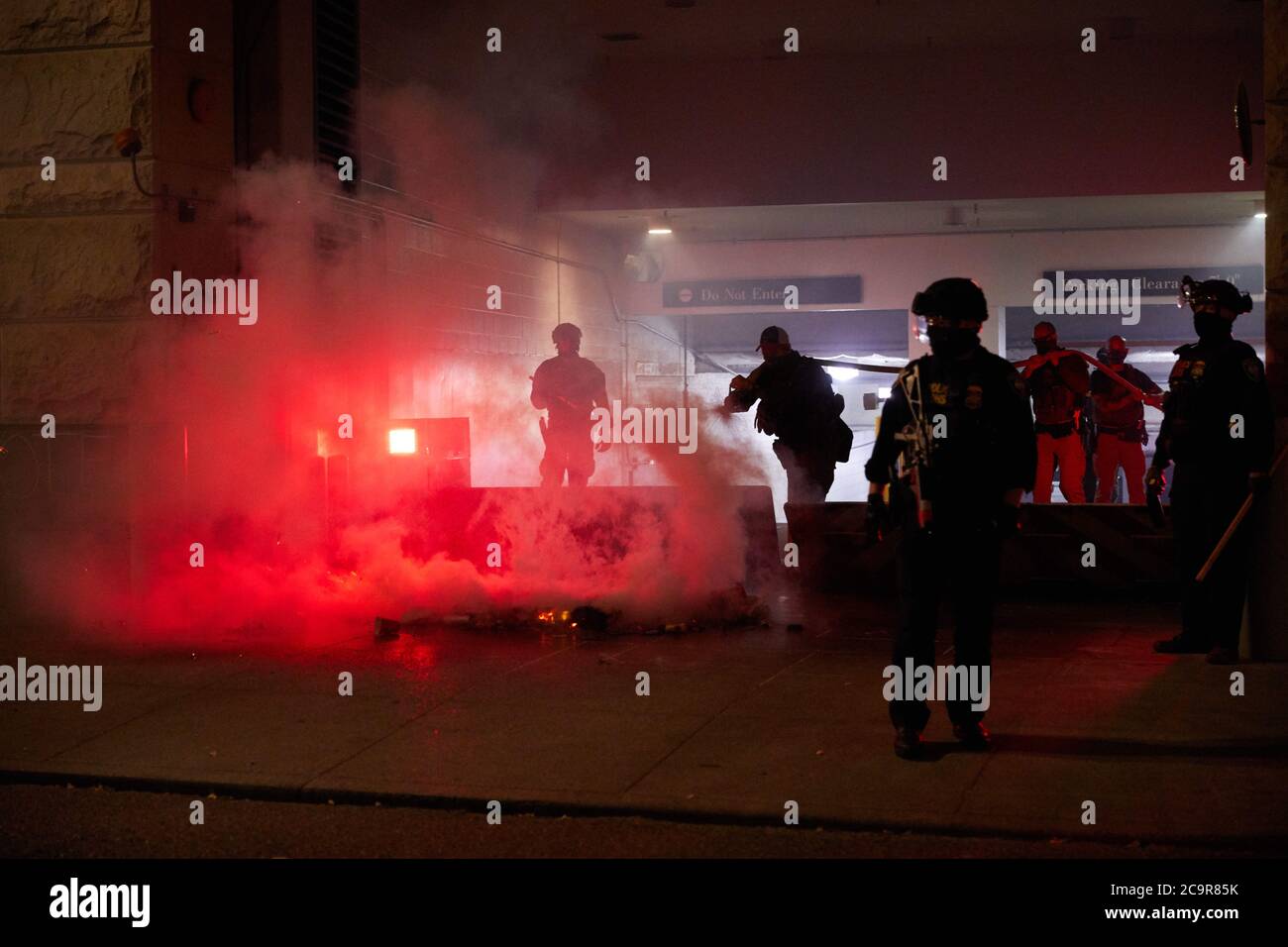 Portland, Oregon, U.S.A. 1st Aug, 2020. A protestor starts a fire behind the Mark O. Hatfield Courthouse. Oregon State Police and Federal Agents come out of the building to extinguish the fire. People protest for equal treatment of Black lives in Portland, Oregon. Credit: Allison Dinner/ZUMA Wire/Alamy Live News Stock Photo