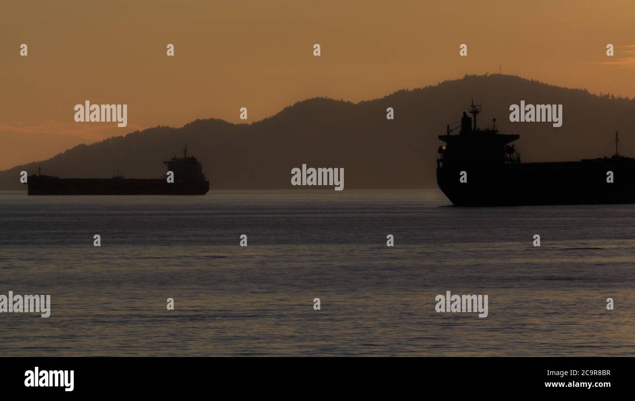 Cargo ferries during sunset by English Bay Vancouver, Canada Stock Photo