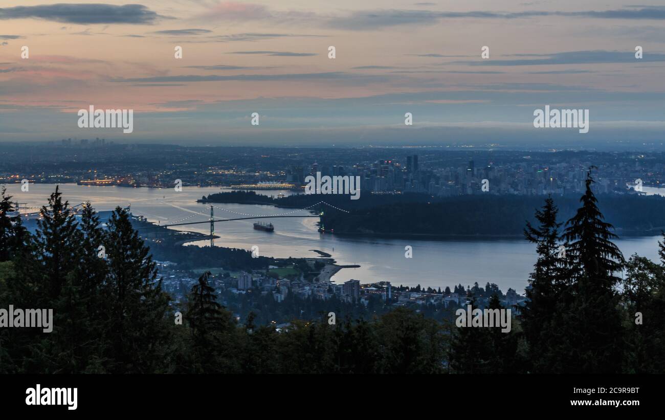 Aerial view of the city of Vancouver looking at the Lions gate bridge and downtown Vancouver during sunrise from the Cypress mountain Viewpoint Stock Photo