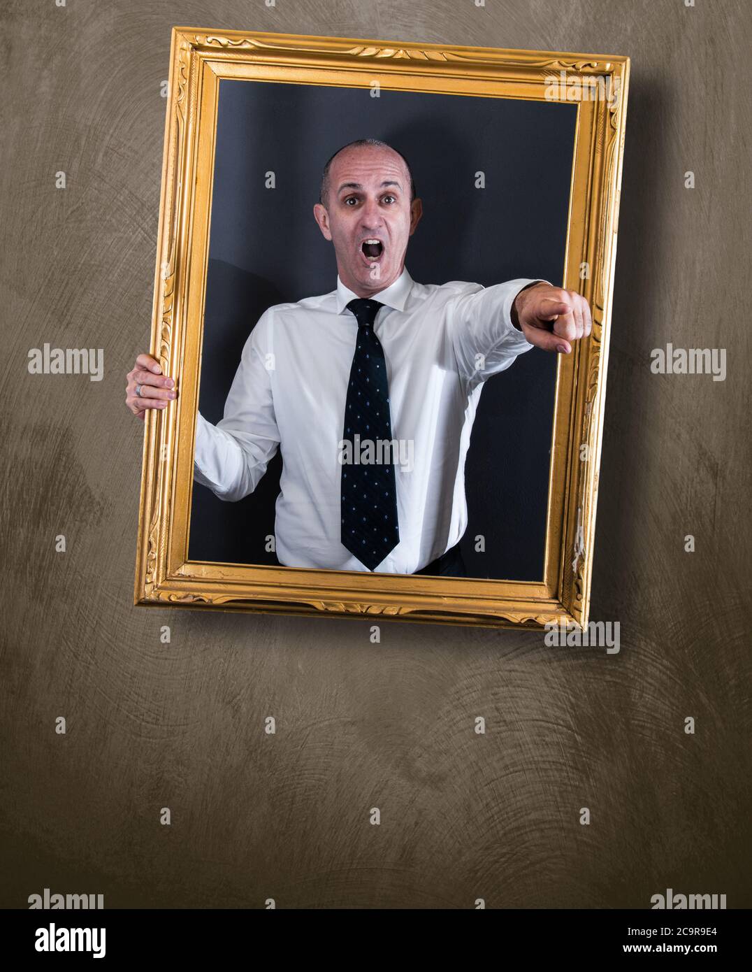 a Businessman in a picture hanging at the wall Stock Photo