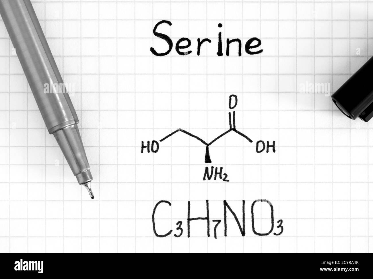 Chemical formula of Serine with pen. Close-up. Stock Photo