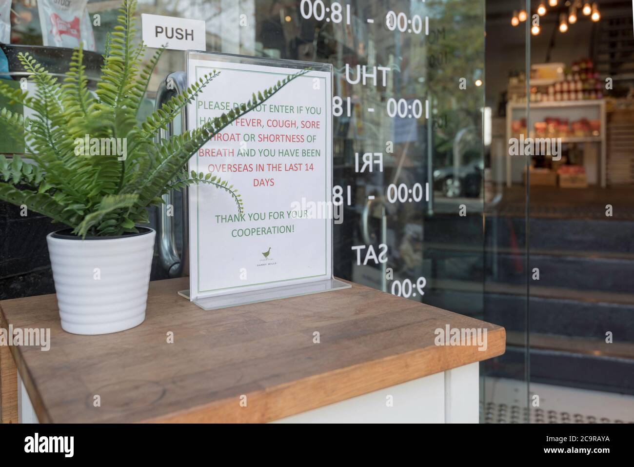 The new normal, a sign outside the entrance to a store in Surry Hills, Sydney, Australia limiting the number of people who can be in the store Stock Photo