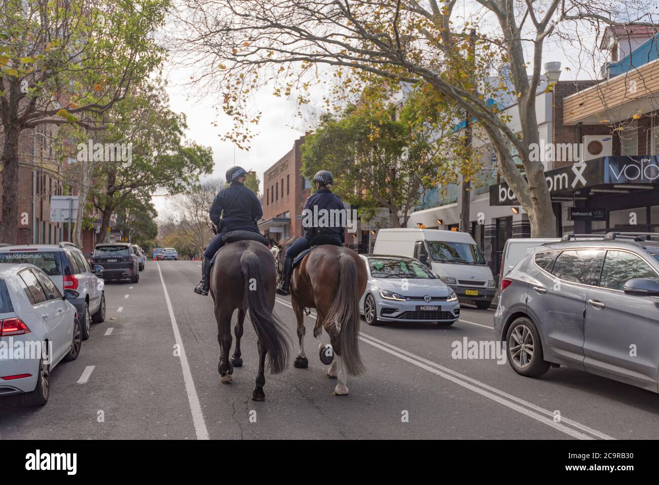 Mounted New South Wales Police women ride their horses along Crown Street in inner Sydney's Surry Hills, Australia Stock Photo