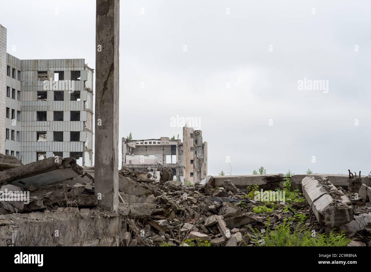 Destroyed large building with a pile of concrete debris and beams ...