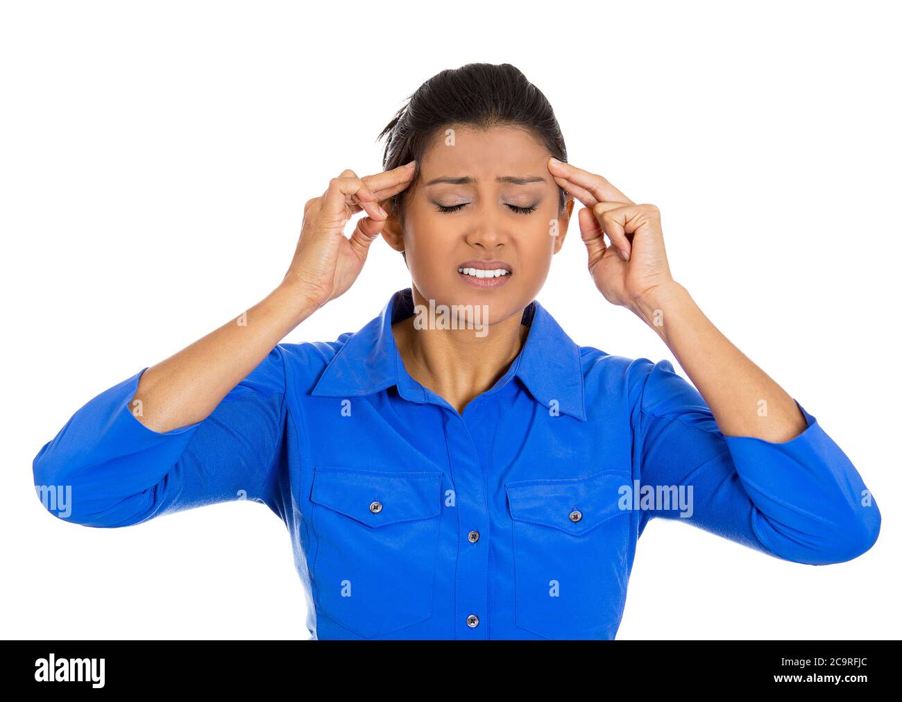 Portrait of an worried young woman having really bad headache placing both hands on temples, isolated on white background. Stock Photo