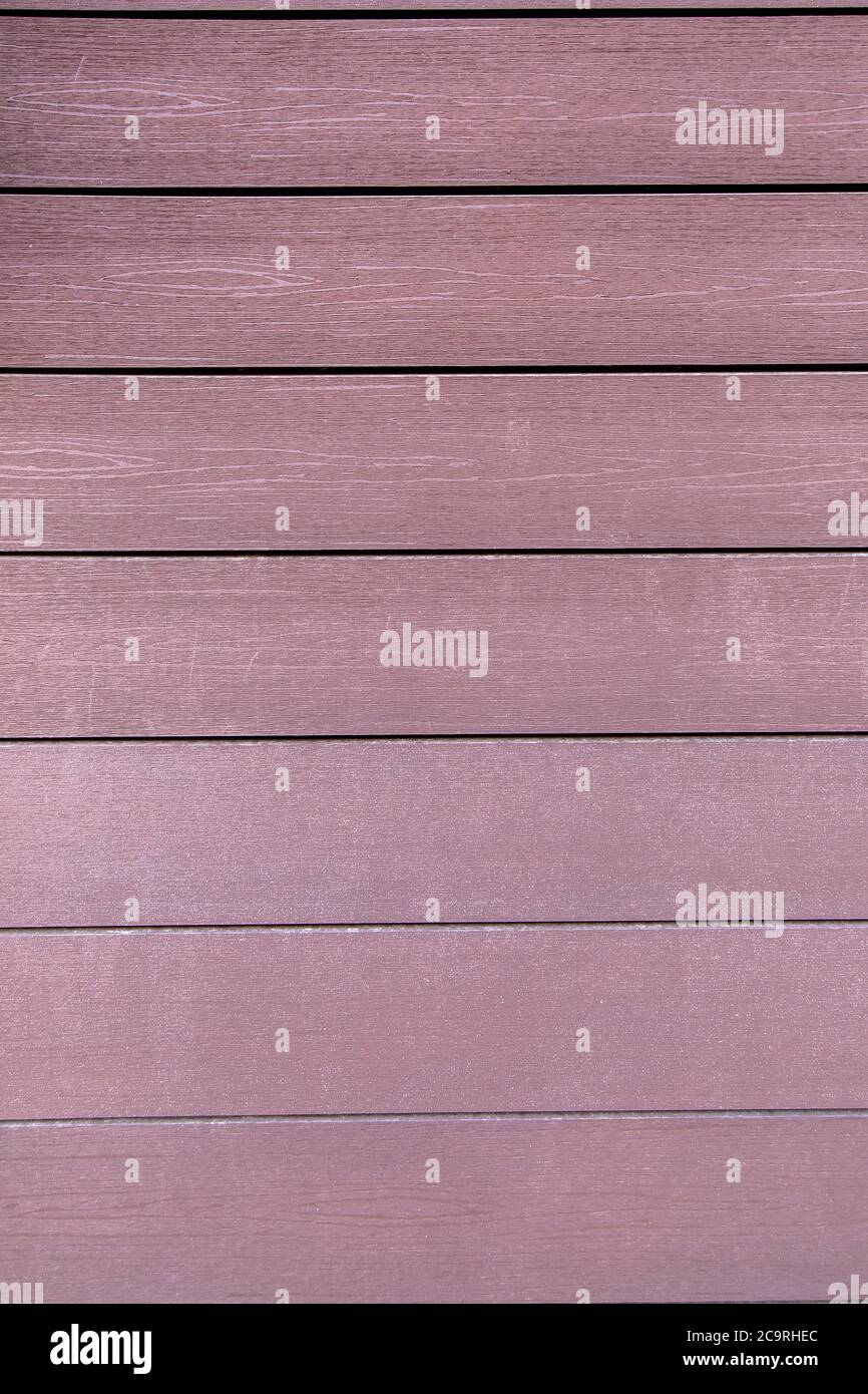wooden texture, artificial moisture resistant material for finishing of facades under a tree. Stock Photo
