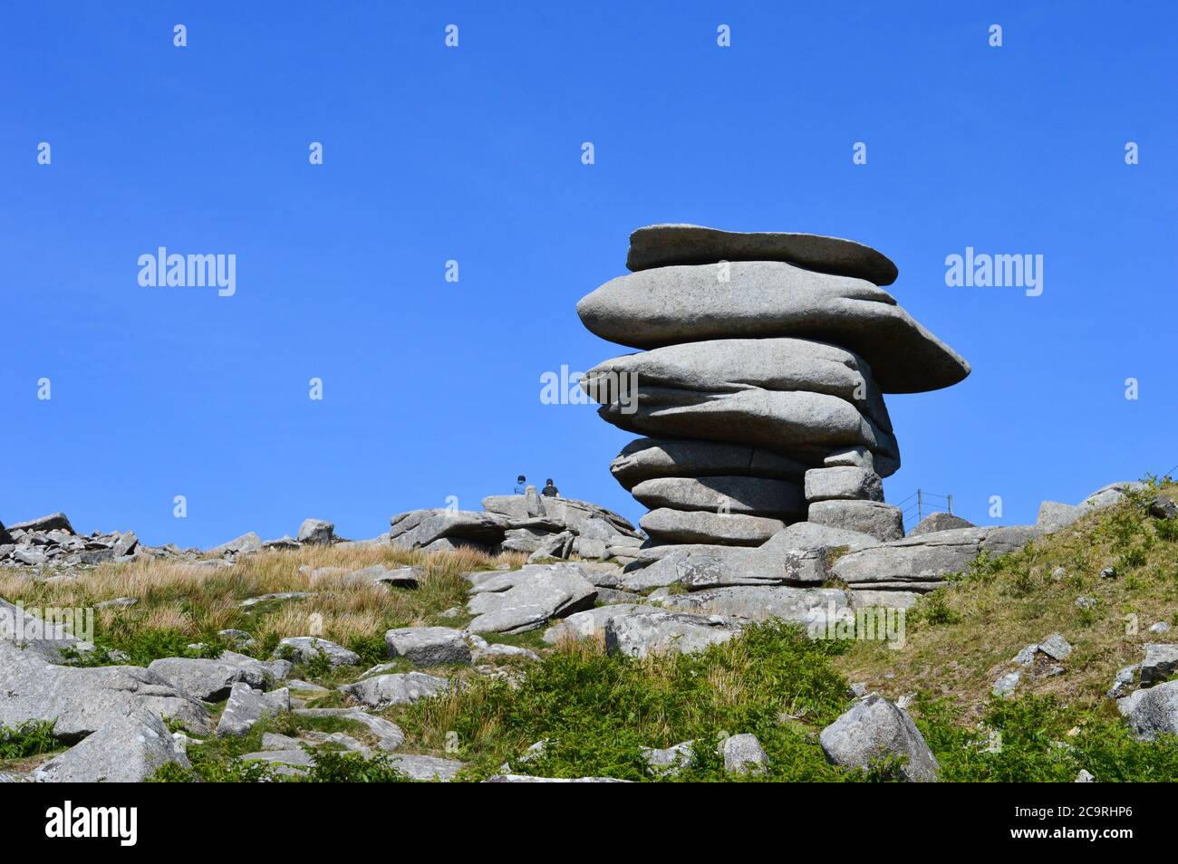 Cheesewring, Cornwall on a sunny day. Named after an old type of cheese press, legend has it this rock formation is a result of a man vs giant fight. Stock Photo