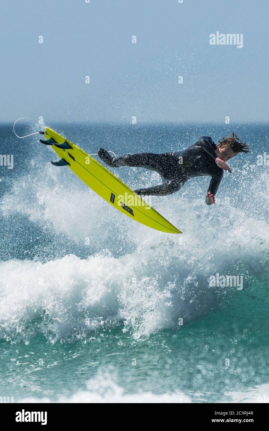 A spectacular wipeout as a surfer loses balance at Fistral in Newquay in Cornwall. Stock Photo