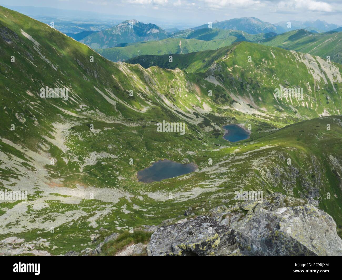 Beautiful vivid blue mountain lakes Horne and Dolne Jamnicke pleso with  green mountain peaks view from the Jamnice sedlo saddle, Western Tatras  Stock Photo - Alamy