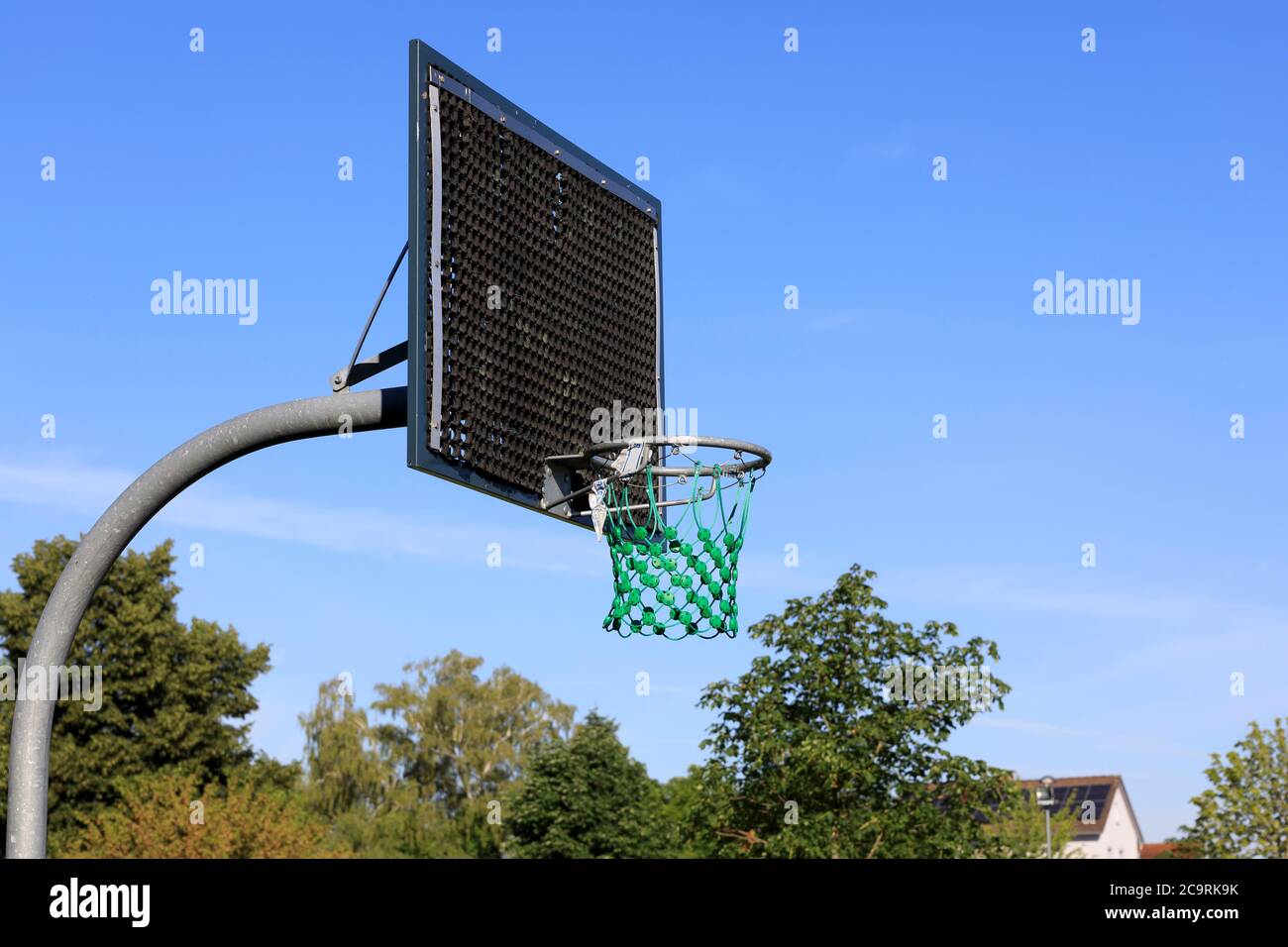 Basketball hoop on a playground under a blue sky Stock Photo Alamy