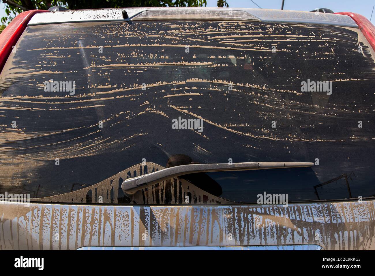 Dusty rear screen of the car, the dirty car the rear view on tinted