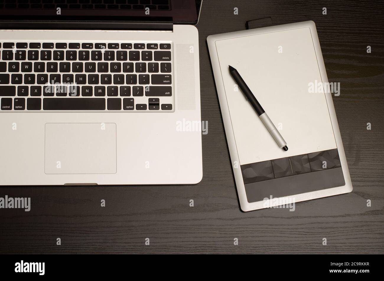 Laptop keyboard and graphics tablet on black table, top view Stock ...