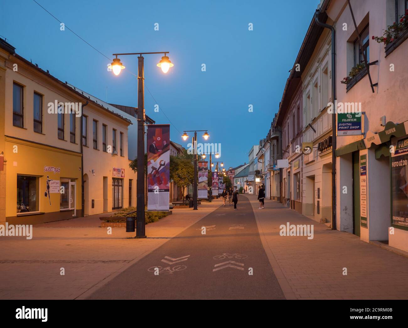 LIPTOVSKY MIKULAS, LIPTOV, SLOVAKIA, July 4, 2019: Pedestrian zone and buildings in the city center of Liptovsky Mikulas town with street lights and Stock Photo