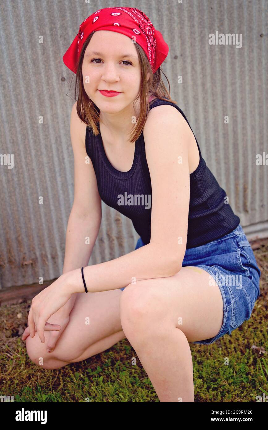 Vintage retro portrait of a girl wearing red bandanna and black tank top Stock Photo