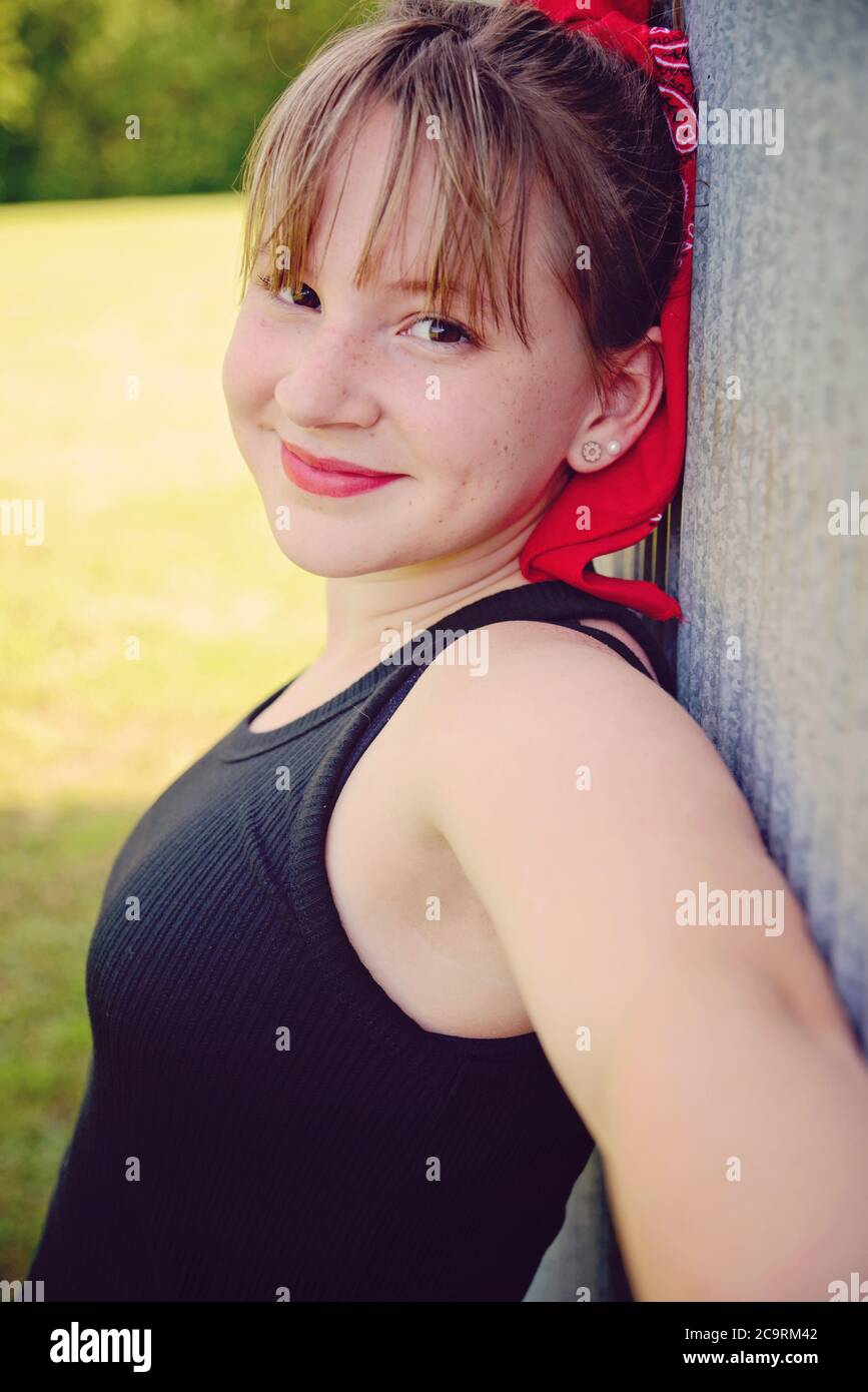 Vintage retro portrait of a girl wearing red bandanna and black tank top Stock Photo