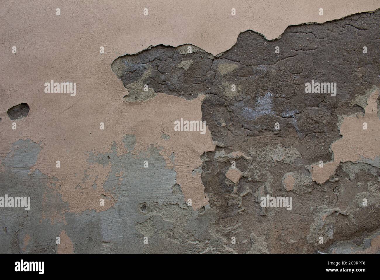 Old dirty weathered wall with layers of plaster falling off ready for repair Stock Photo