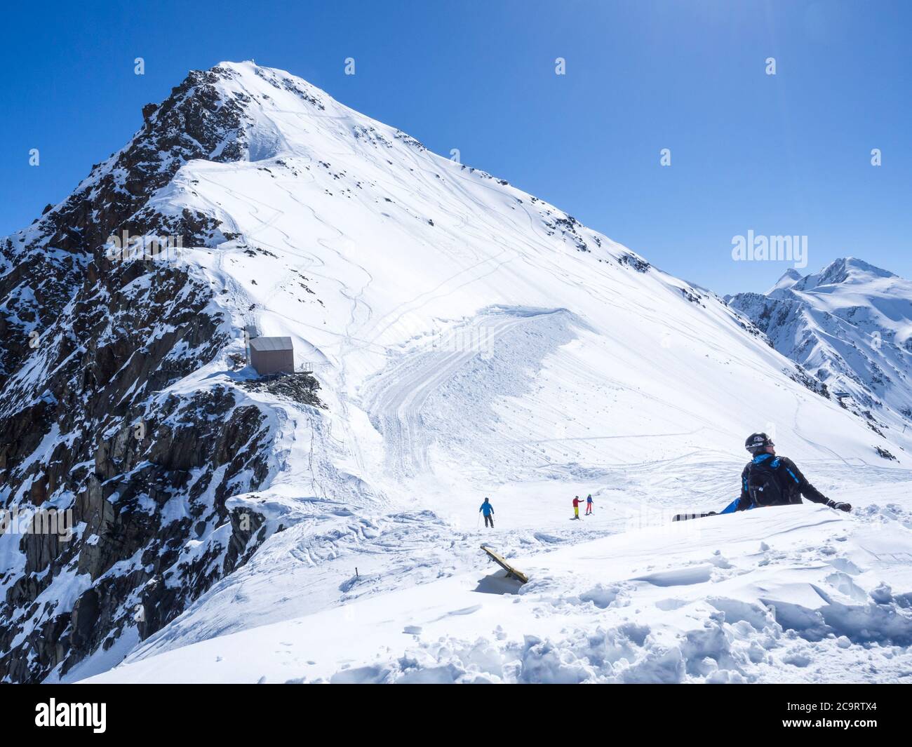 Stubai Glacier AUSTRIA May 2 2019 Snowboarder sitting and relaxing at the top of Schaufelspitze mountain at Stubai Gletscher ski resort. Snow cove Stock Photo Alamy