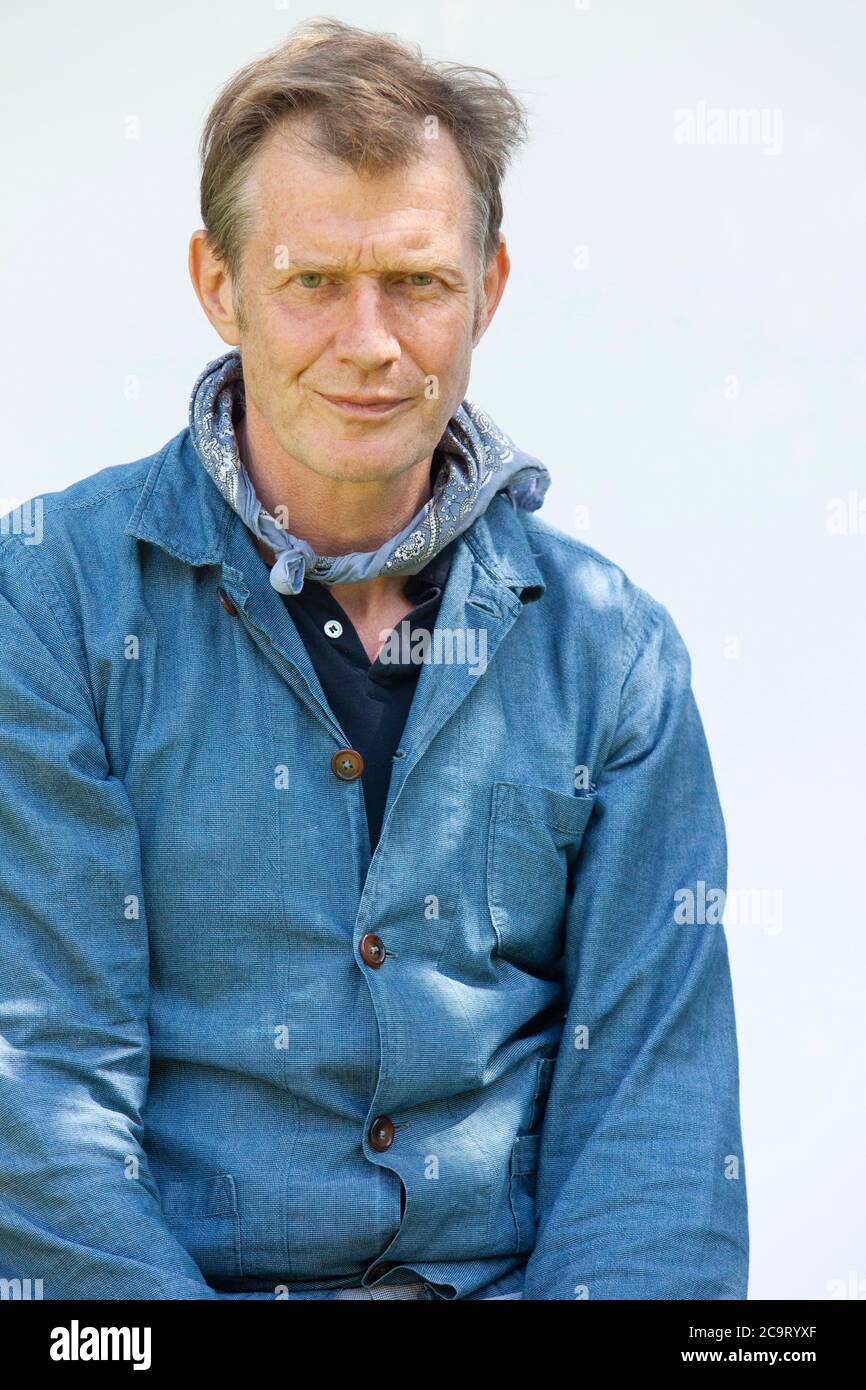 Portrait of the movie actor Jason Flemyng photographed in a blue denim shirt against a white backdrop. Anna Watson/Alamy Stock Photo