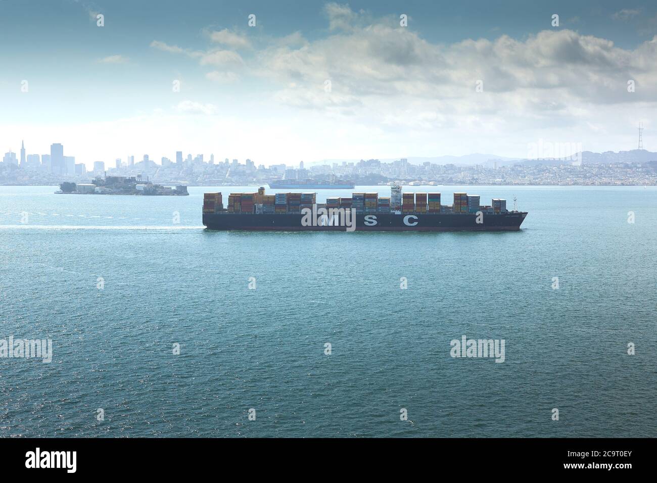 The Container Ship MSC ARIANE Passes Alcatraz Island In The San Francisco Bay As She Departs Oakland For The Pacific Ocean. Stock Photo
