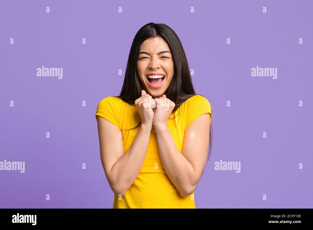 Happy Emotions. Overjoyed asian girl shouting and clenched fists with excitement Stock Photo
