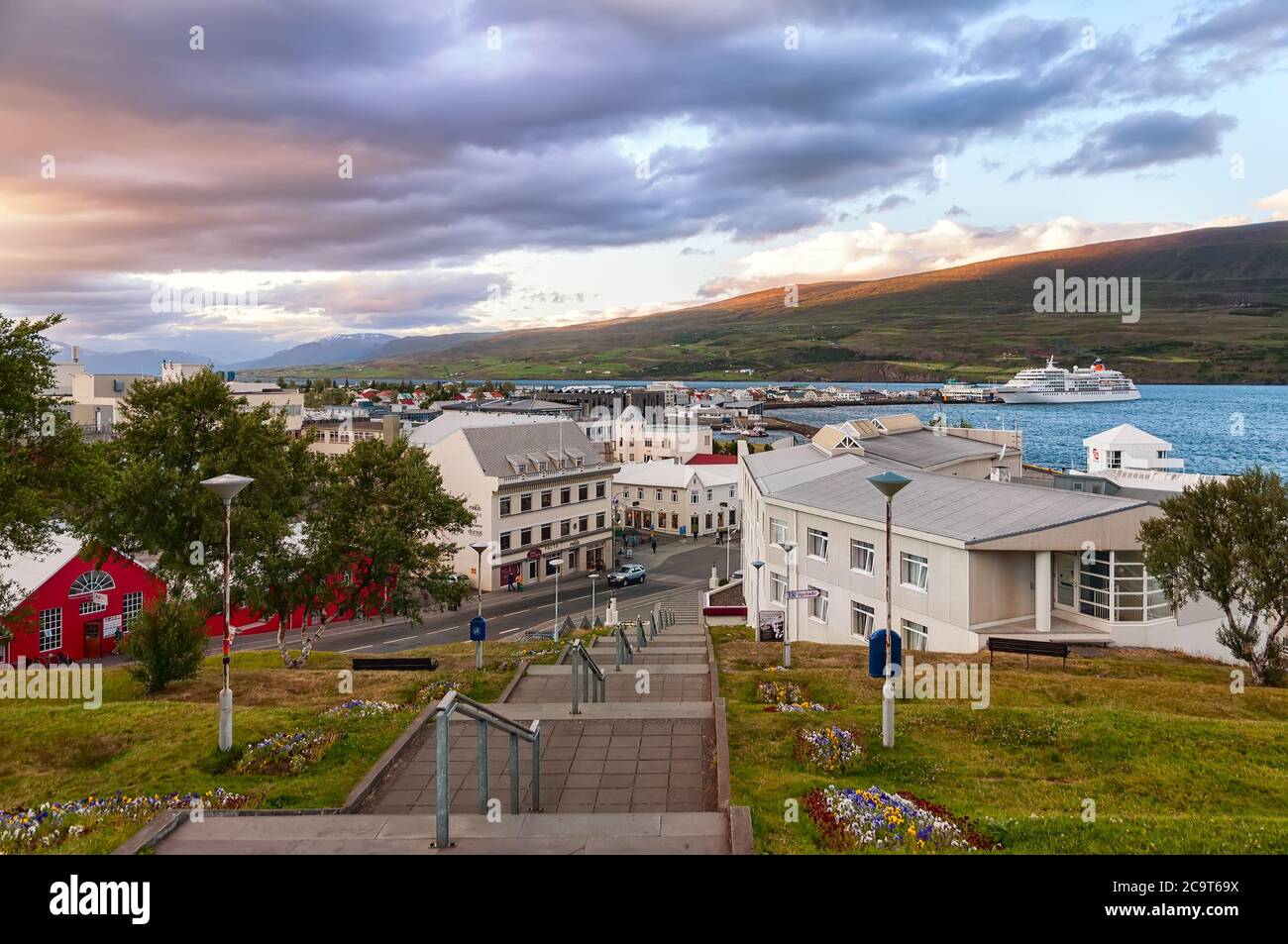 Akureyri, Iceland - August 8, 2012: Dramatic sky over Akureyri center at dusk. Akureyri, called the Capital of North Iceland, is an important port Stock Photo