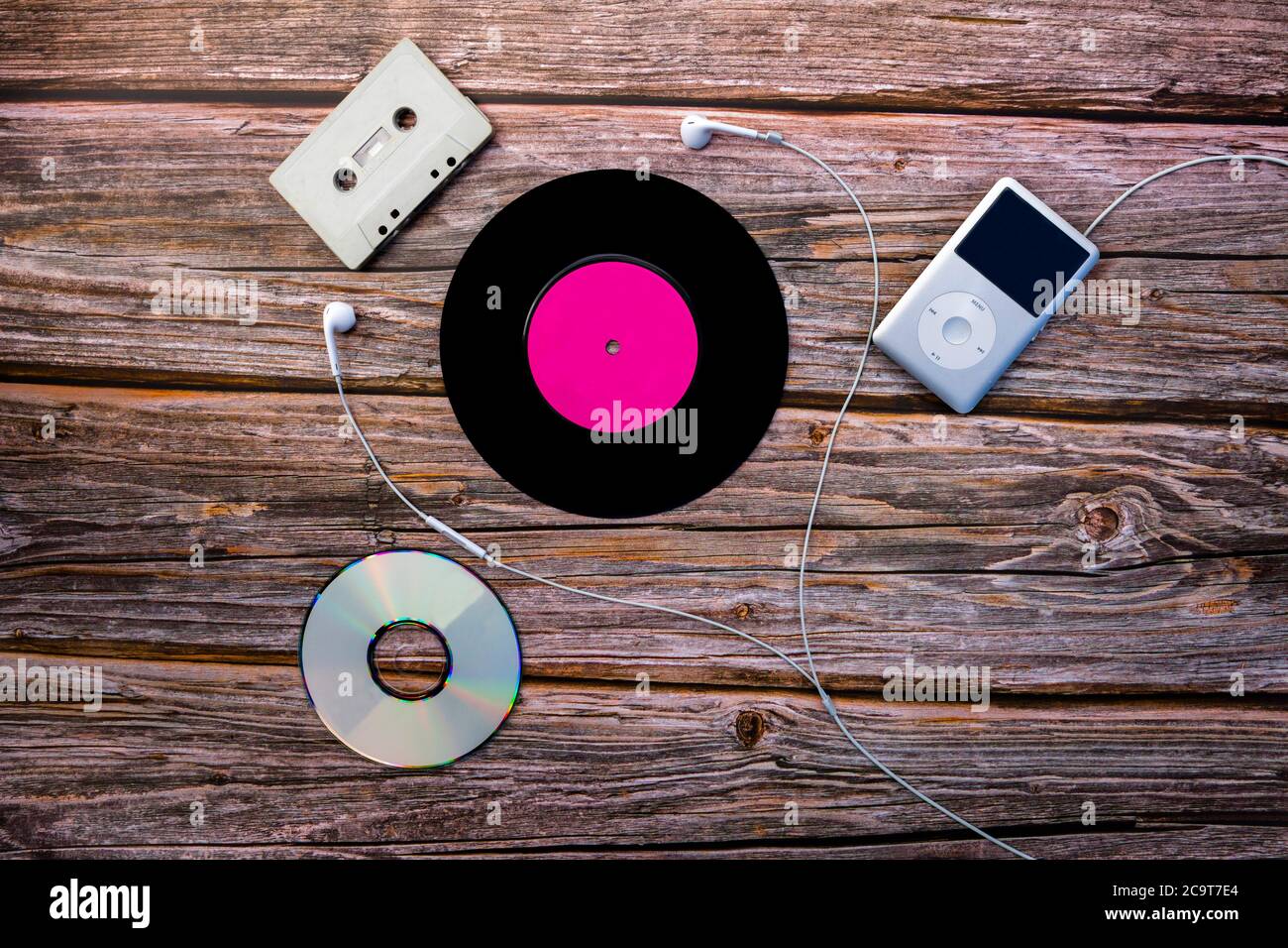 Multiple music formats with a vinyl record, cassette tape, compact disc and iPod Classic. Stock Photo