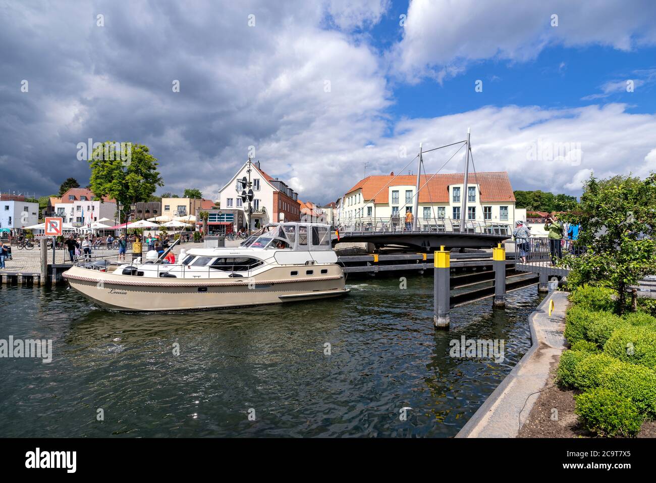 motorboat passing the swing bridge in Malchow, Germany Stock Photo