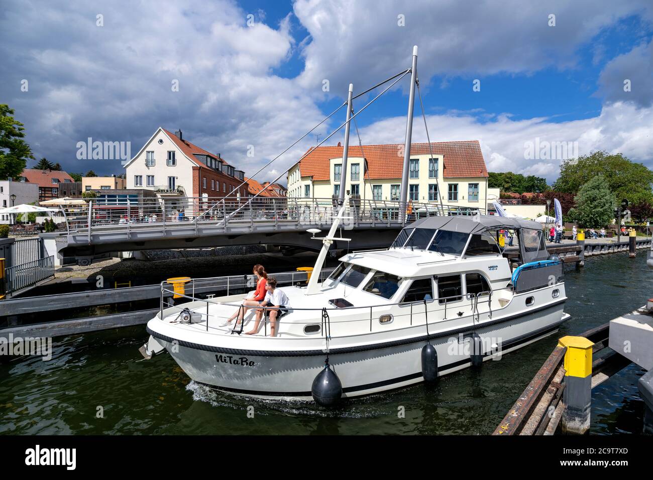 motorboat passing the swing bridge in Malchow, Germany Stock Photo