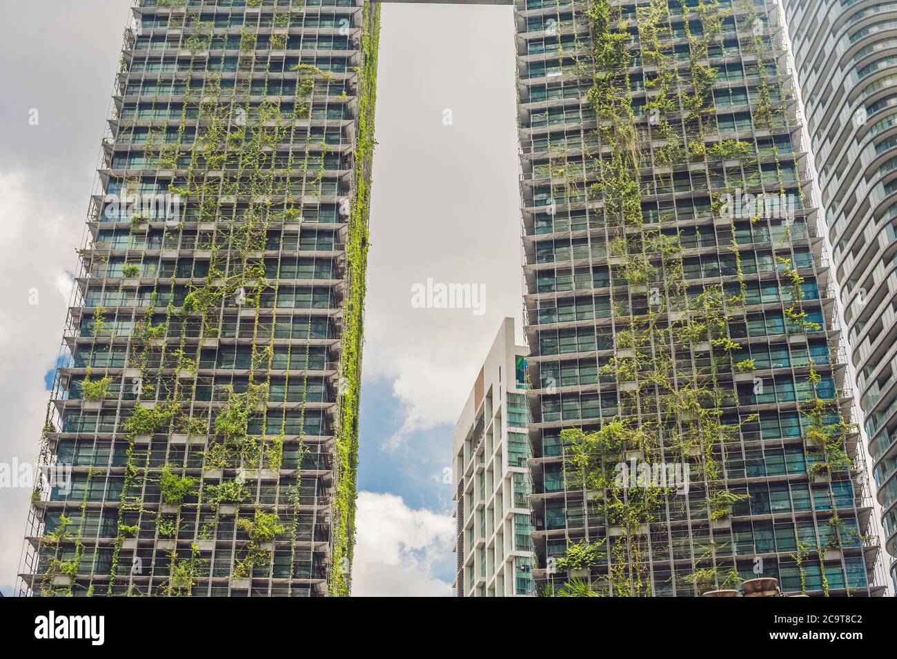 KUALA LUMPUR, MALAYSIA - 24 FEBRUARY 2017: Eco architecture. Green skyscraper building with plants growing on the facade. Ecology and green living in Stock Photo
