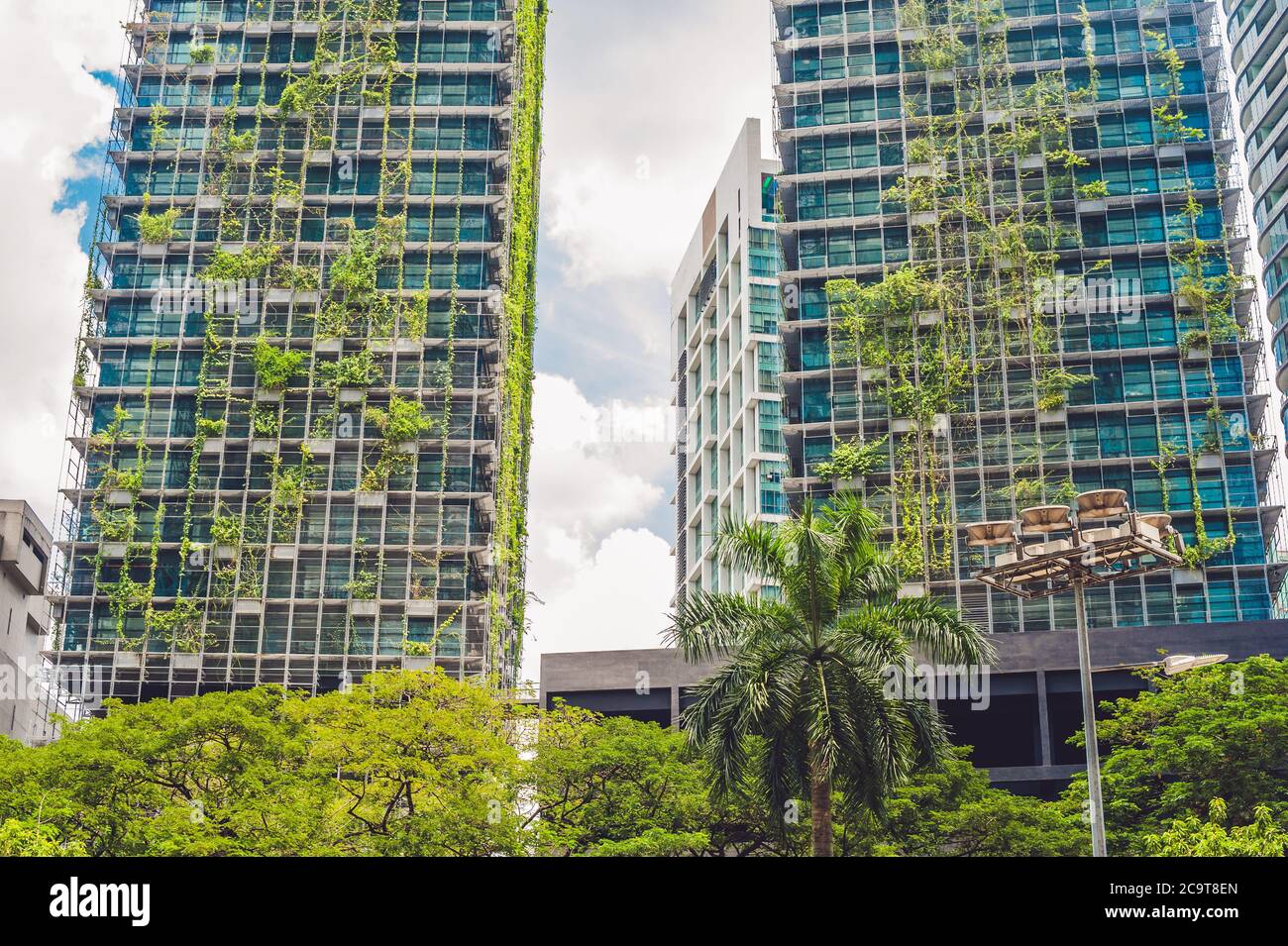 KUALA LUMPUR, MALAYSIA - 24 FEBRUARY 2017: Eco architecture. Green skyscraper building with plants growing on the facade. Ecology and green living in Stock Photo