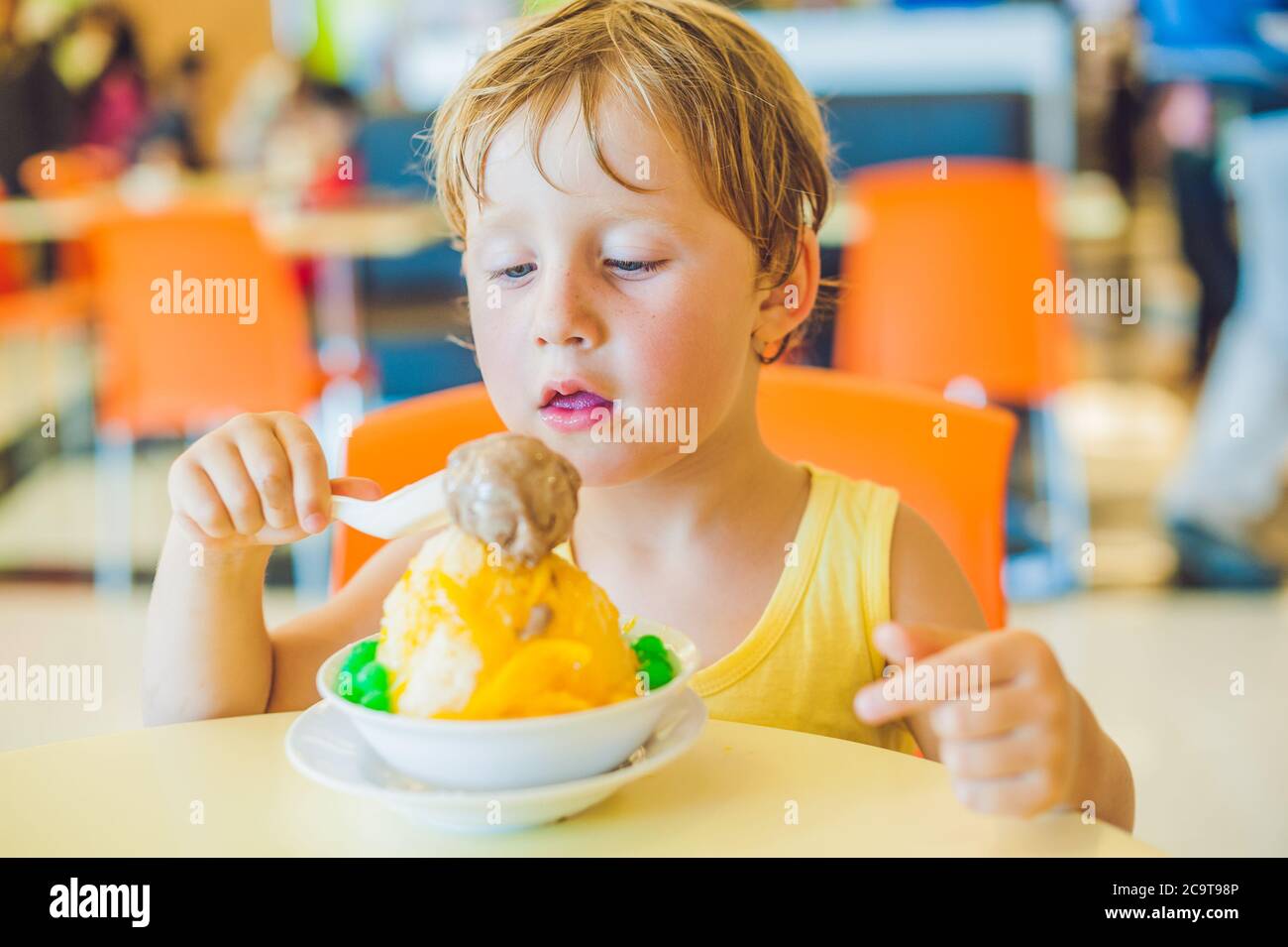Child Eating Ice Cream Sundae High Resolution Stock Photography and