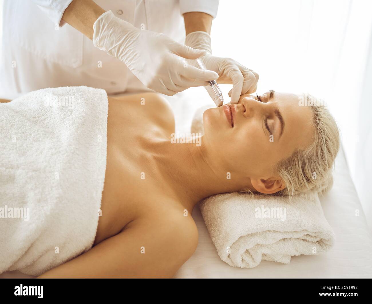 Doctor doing injection face blonde hi-res stock photography and images ...