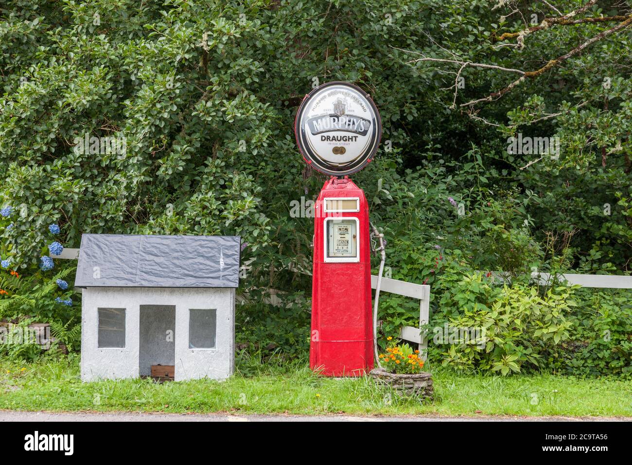 Lauragh, Kerry, Ireland. 01st August, 2020. An old vintage petrol pump with a Murphy's Irish Stout sign attached on the roadside at Lauragh, Co. Kerry Stock Photo