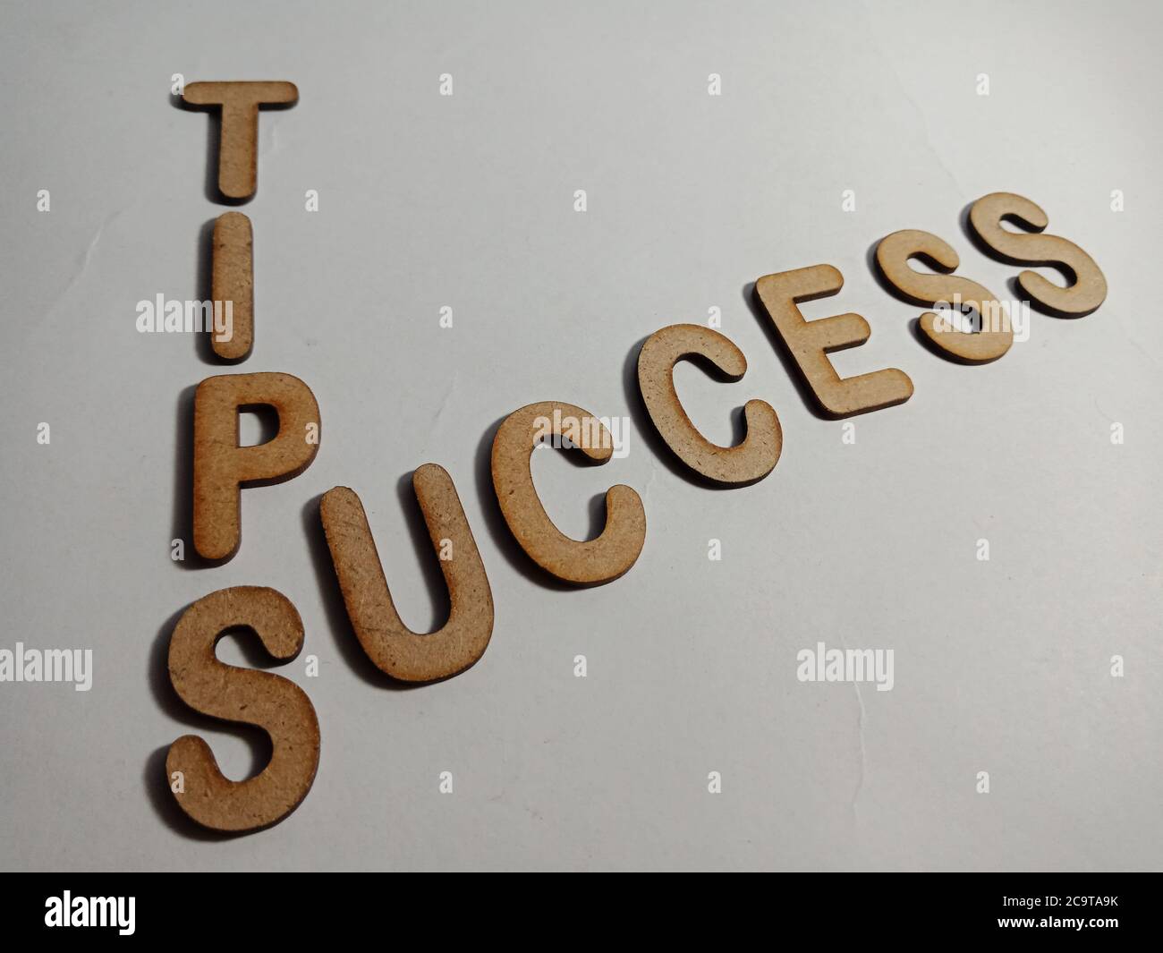 Success Tips Word Presented On White Surface With Wooden Cross Text ...