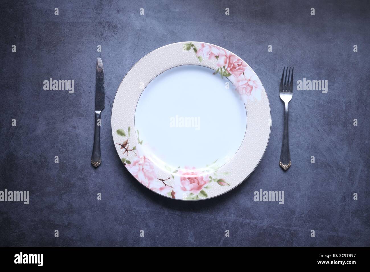 cutlery and empty plate on black background top down Stock Photo