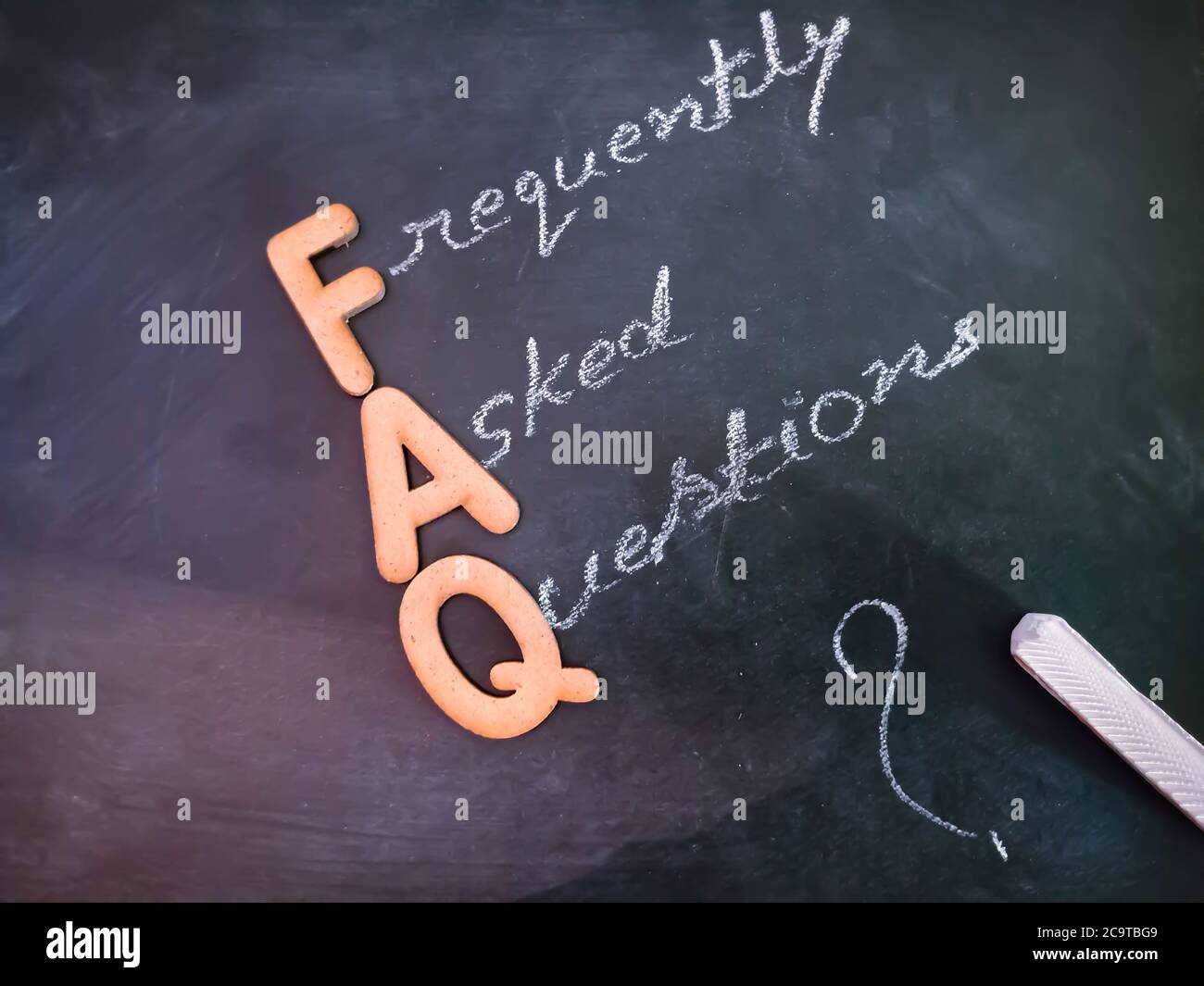 Frequently ask question text presented for active business education concept on chalkboard abstract background. Stock Photo