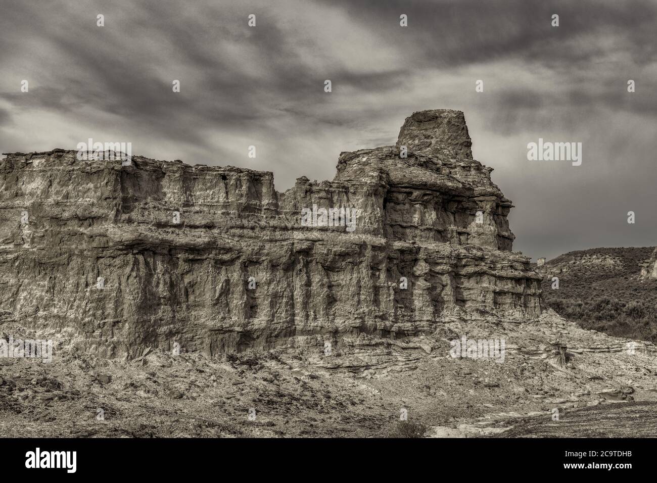 Desert landscape with a rock formation and cloudy sky Stock Photo - Alamy