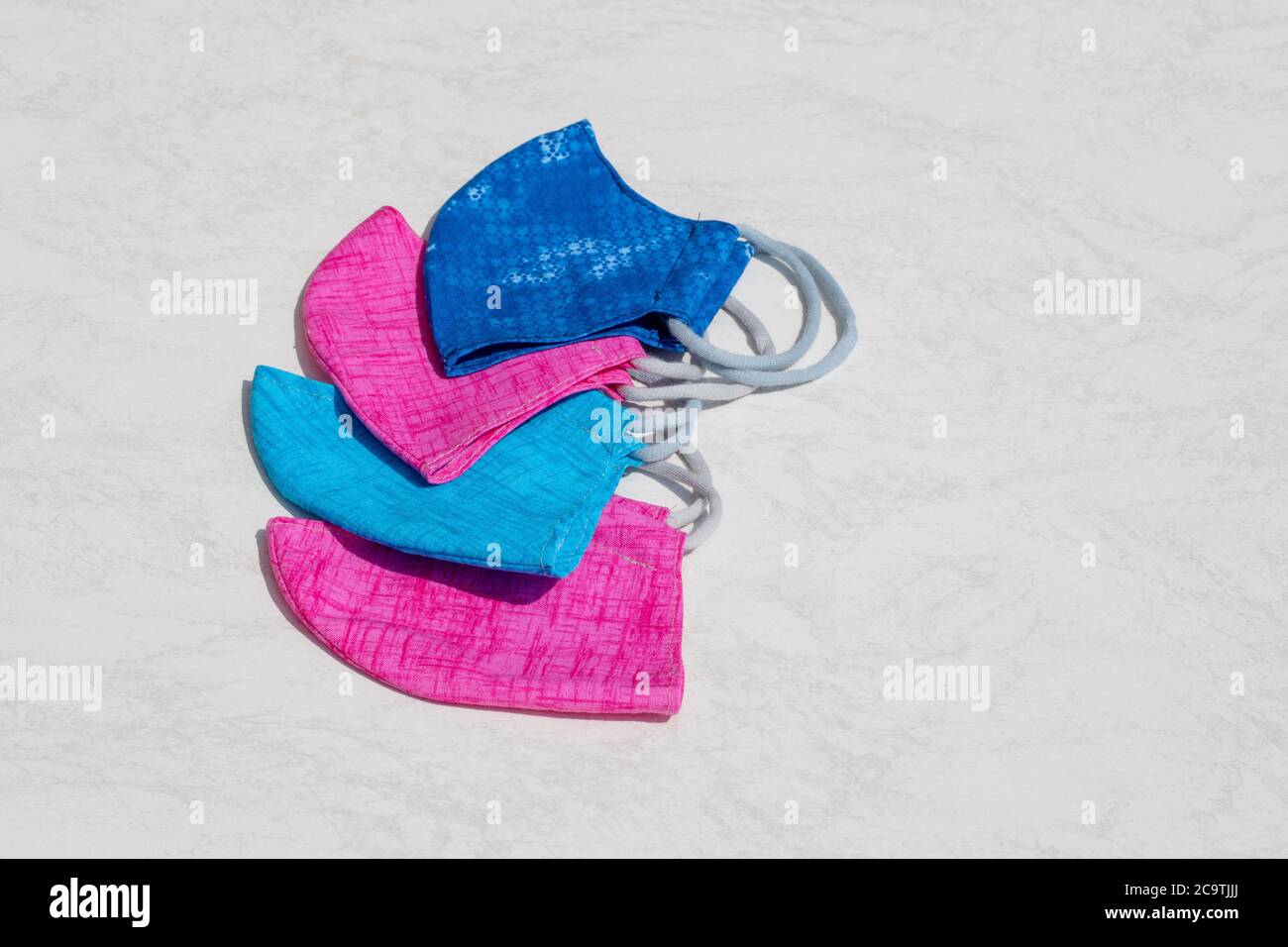 Selection of four community masks arranged one above the other on a ...