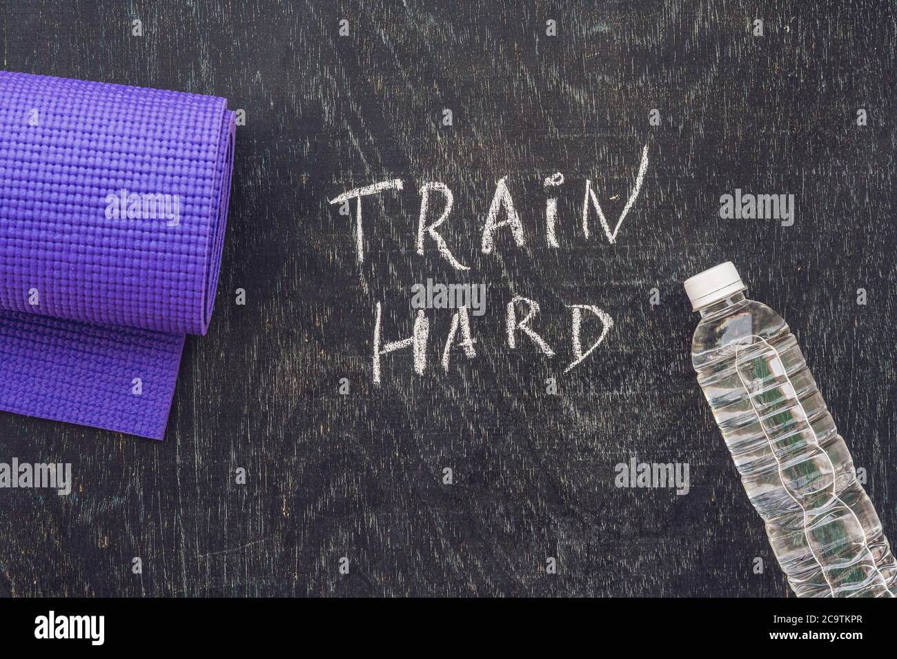 Sports motivational text. Train hard On a chalk board Stock Photo