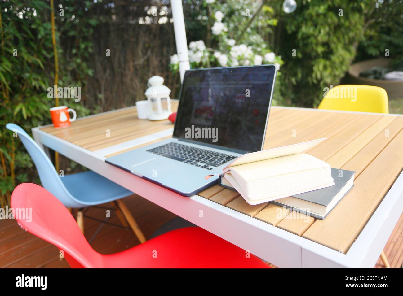 working from home on a modern teak deck and table Stock Photo