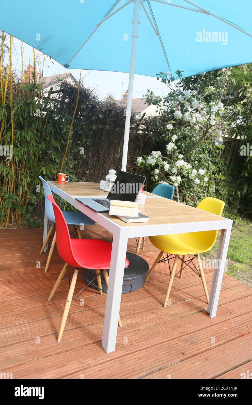 working from home on a modern teak deck and table side view Stock Photo