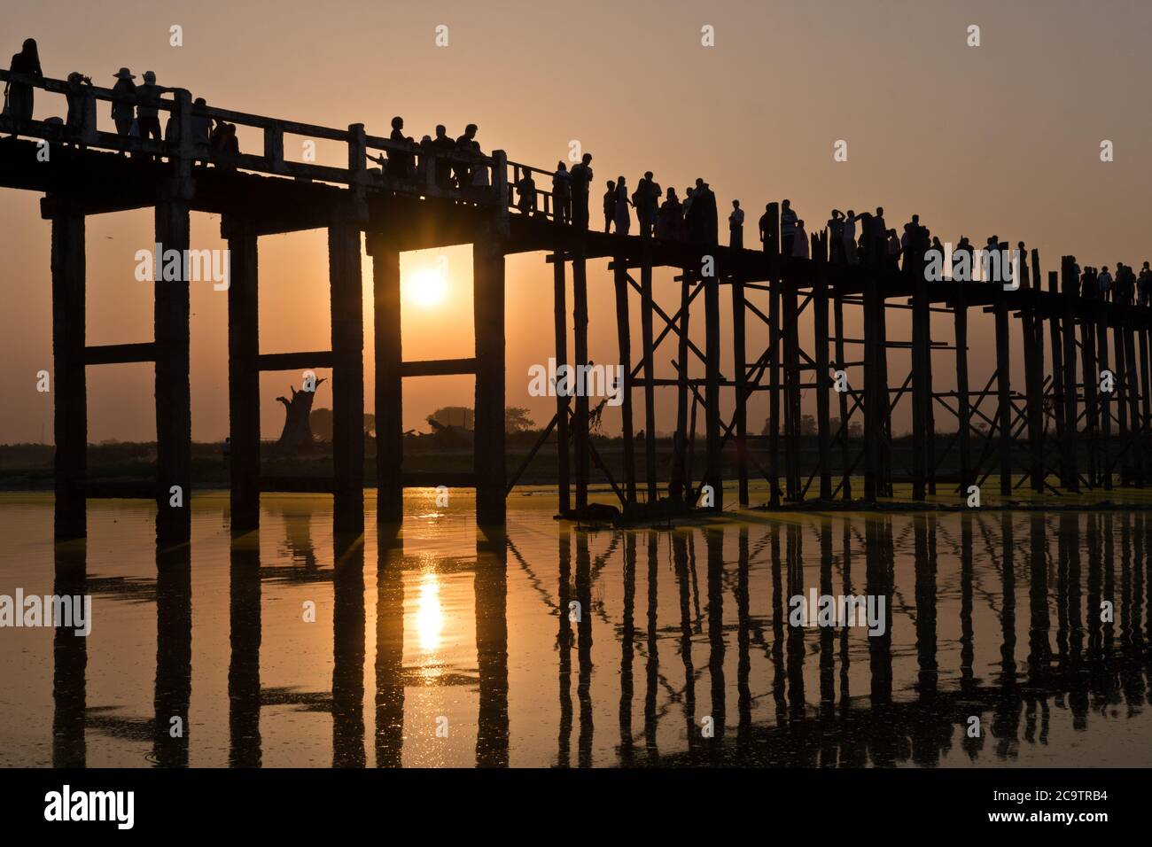U Bein Bridge with people and sunset reflection, Amarapura, Mandalay, Myanmar, Asia Stock Photo