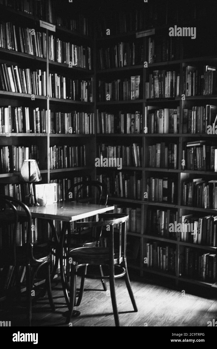 Interior of a cafe bar with books on walls, black and white picture Stock Photo