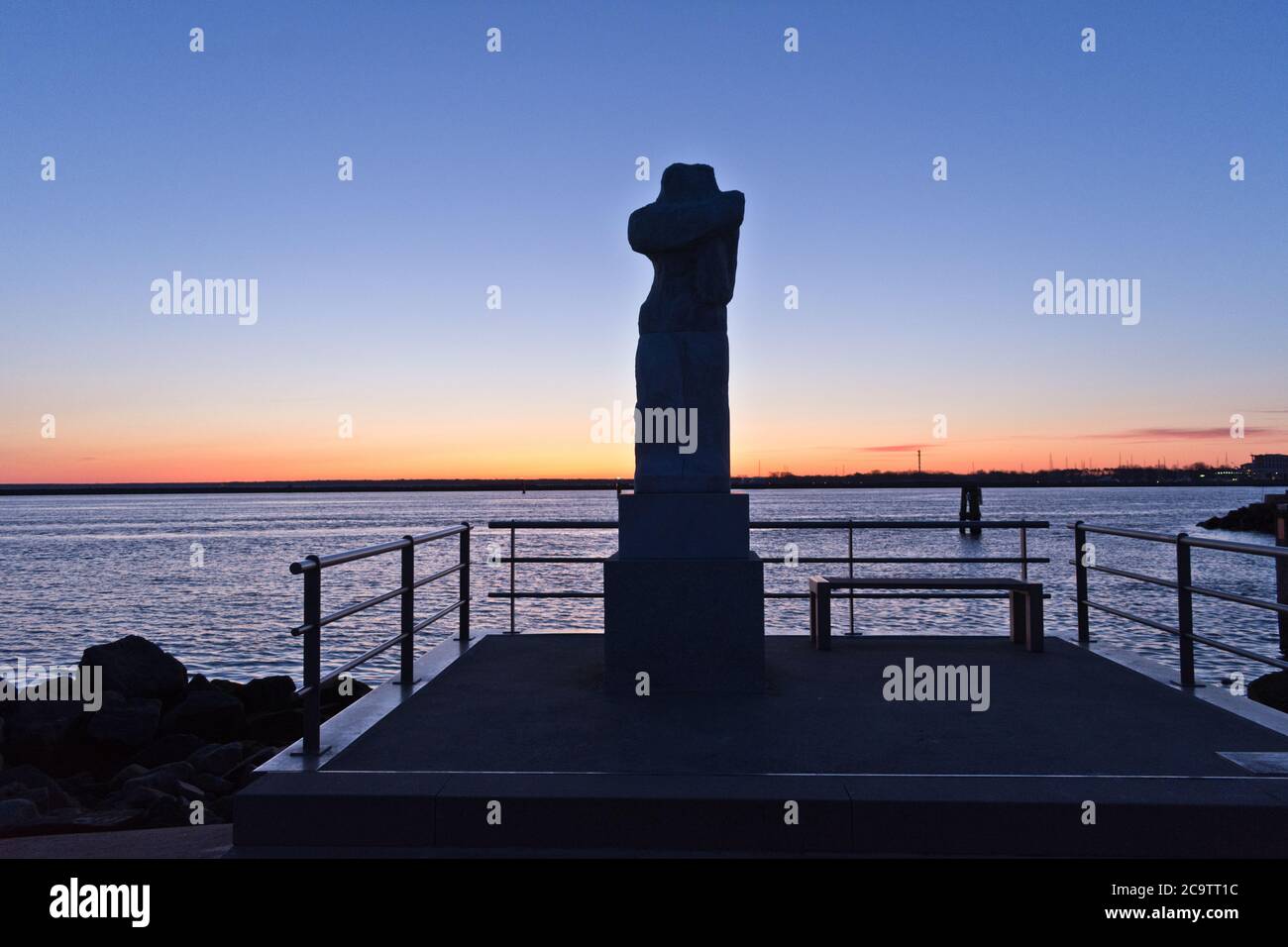 Statue at the Mole of Warnemünde While Sunrise, Rostock, Baltic Sea, Mecklenburg Western Pomerania, Germany, Europe Stock Photo