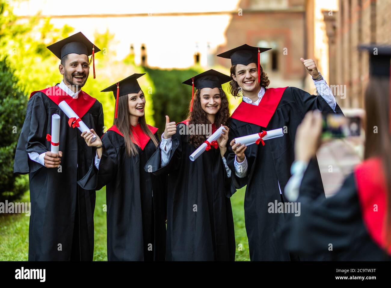Graduation students take picture on the camera in front of University ...