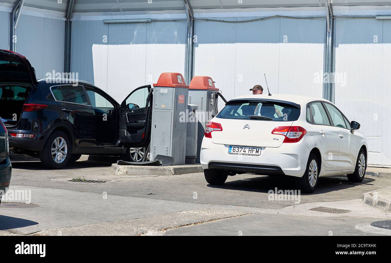 Madrid, Spain - July 18, 2020: People wash their car with pressure washing on a Sunday noon. Stock Photo